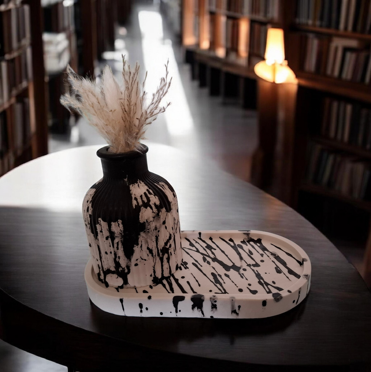 un plateau blanc rayé noir avec son petit vase